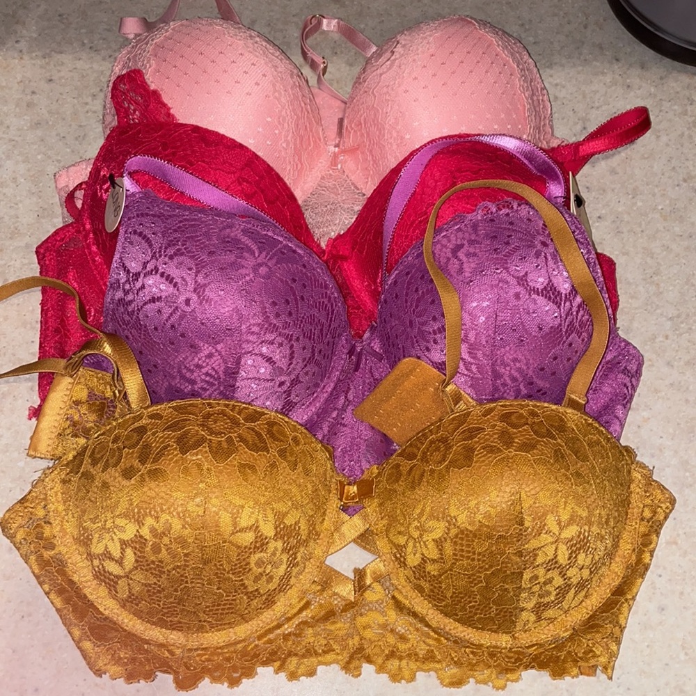 Lot of four bralettes with push up padding. Pink, red, purple, and gold.